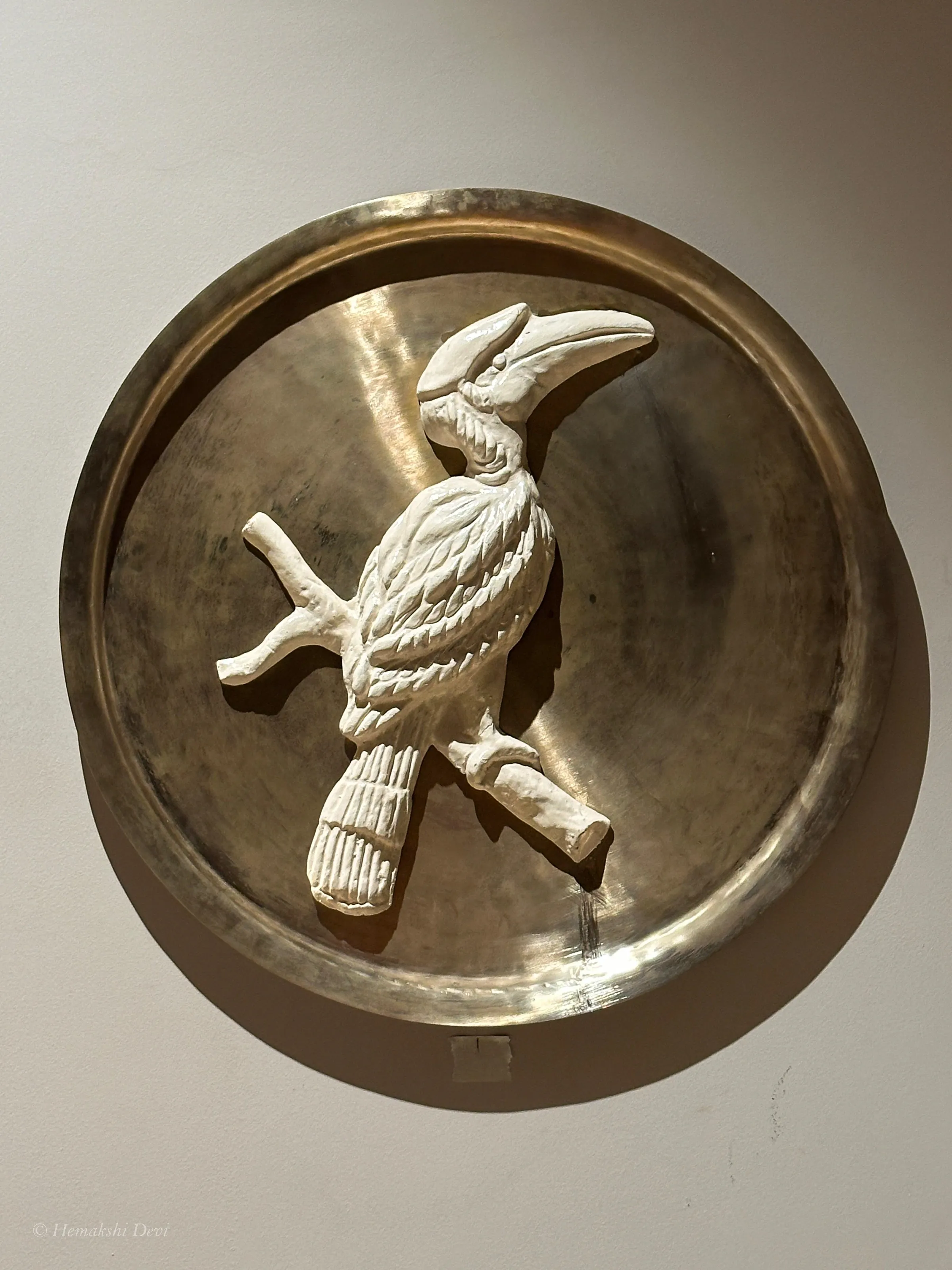 Detail of a bell-metal medallion with a Kaziranga bird relief